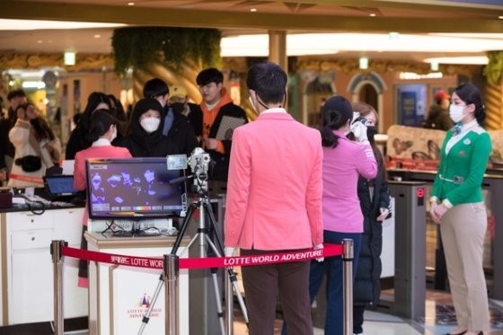 图为乐天世界在入口检票的同时使用红外感应相机对游客进行测温