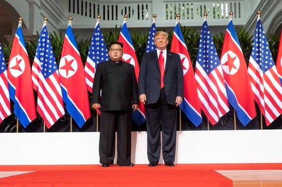 2018年6月，朝鲜国务委员长金正恩和美国总统特朗普在新加坡圣淘沙岛上会面。图为两人在史上首次朝美首脑会谈前的合影留念。【照片来自中央照片库】