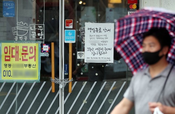 10月8日首尔中区明洞某店铺大门上挂着铁链锁，上面贴着停业告示。【照片来源：NEWS1】