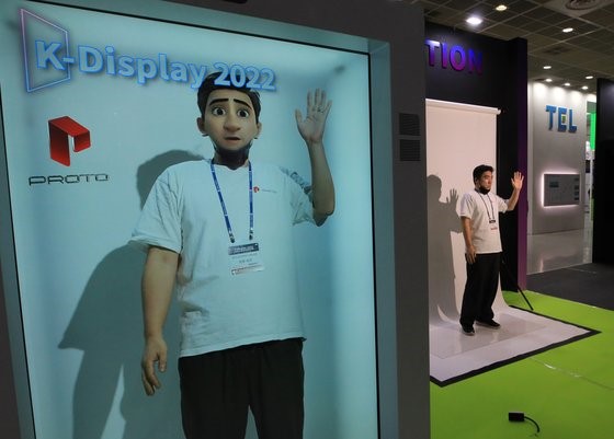 图为10日，在首尔江南区COEX会展中心举行的韩国显示器产业展览会上，一位参观者正在体验应用了“全息瞬移”(Holoportation)技术的虚拟现实。 Holoportation是“Hologram”和“Teleportation”的合成词，指的是实时传输立体影像技术。【照片来源：NEWS1】 