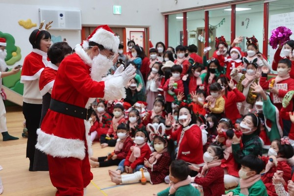 图为21日上午，装扮成圣诞老人的韩国国会议长金振杓来到首尔汝矣岛国会托儿所，正在和孩子们一起玩耍。【照片来源：NEWSIS】
